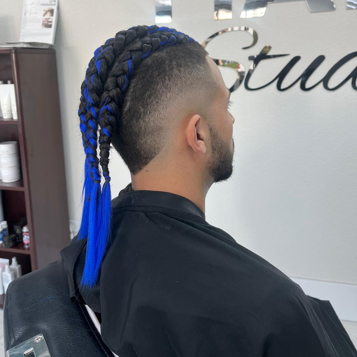 Professional men’s braiding with blue extensions and clean fade haircut at Tru Hair Studio in Brighton, Colorado.