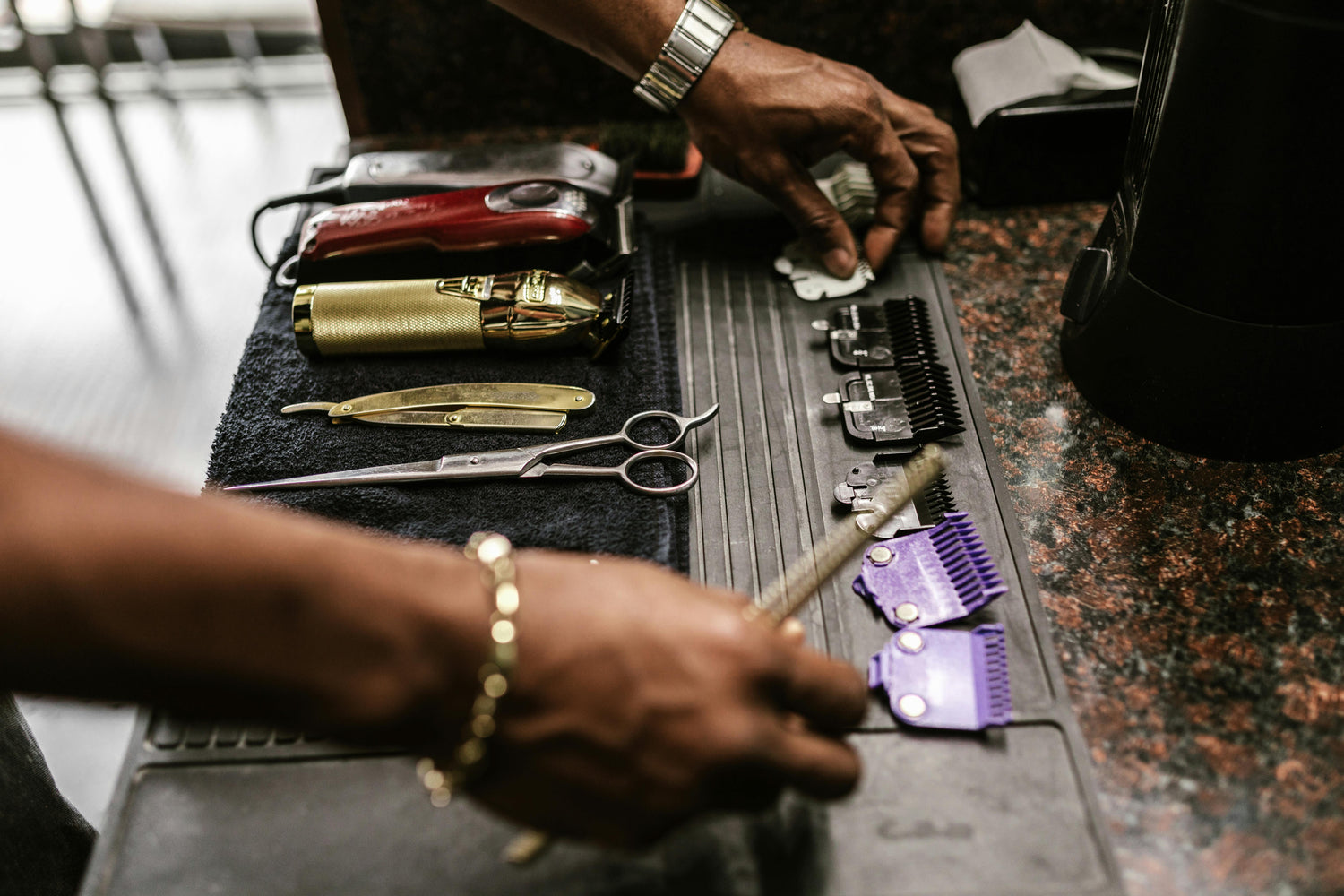 Close-up of barber clippers, scissors, and tools on a workstation at Tru Hair Studio in Brighton, Colorado, offering professional barbering services.