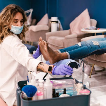 Nail technician performing a professional spa pedicure at Tru Hair Studio in Brighton, CO.