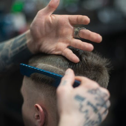 Barber creating a clean low fade haircut for a client at Tru Hair Studio, a professional Brighton, Colorado barbershop.